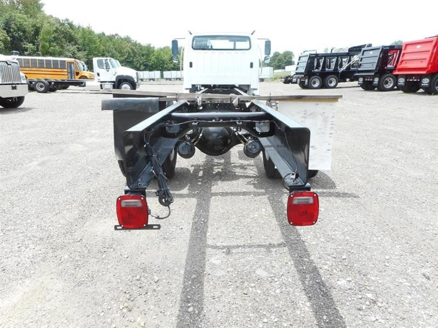 Freightliner M2 106 chassis showing rear frame and taillights with connectors and mounting brackets.