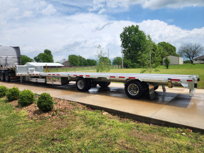 New Wabash drop deck trailer with long flatbed, dual rear axles, and low-profile frame; VIN 1JJG532A5SC561844 notations in listing context.