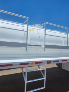 Vacuum steel tank trailer side view showing access ladder and safety rails.