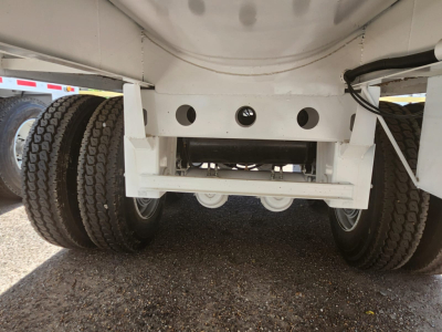 Conquest vacuum trailer rear view showing tandem axles and undercarriage components.