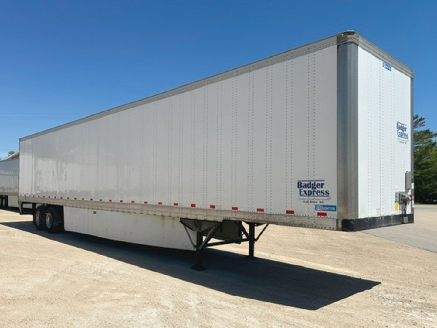 Trailer with white box and Badger Express logo on side showing dual rear doors and tandem axles.
