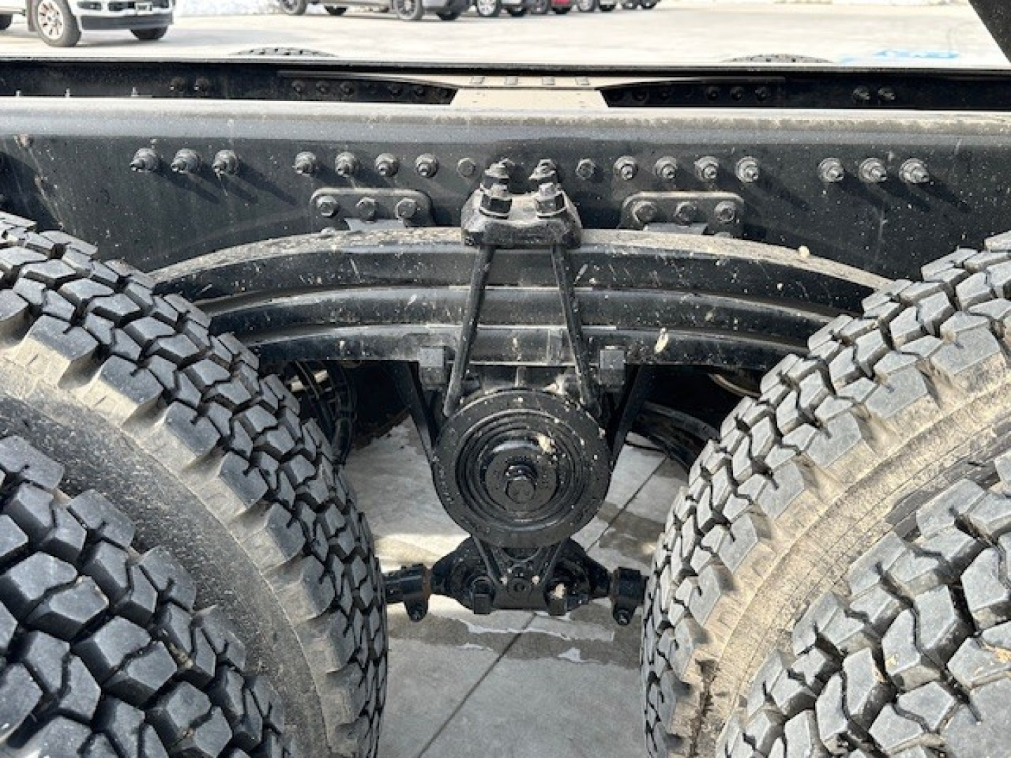 Mack GR104F rear axle and dual tires showing drivetrain components and suspension mounts.