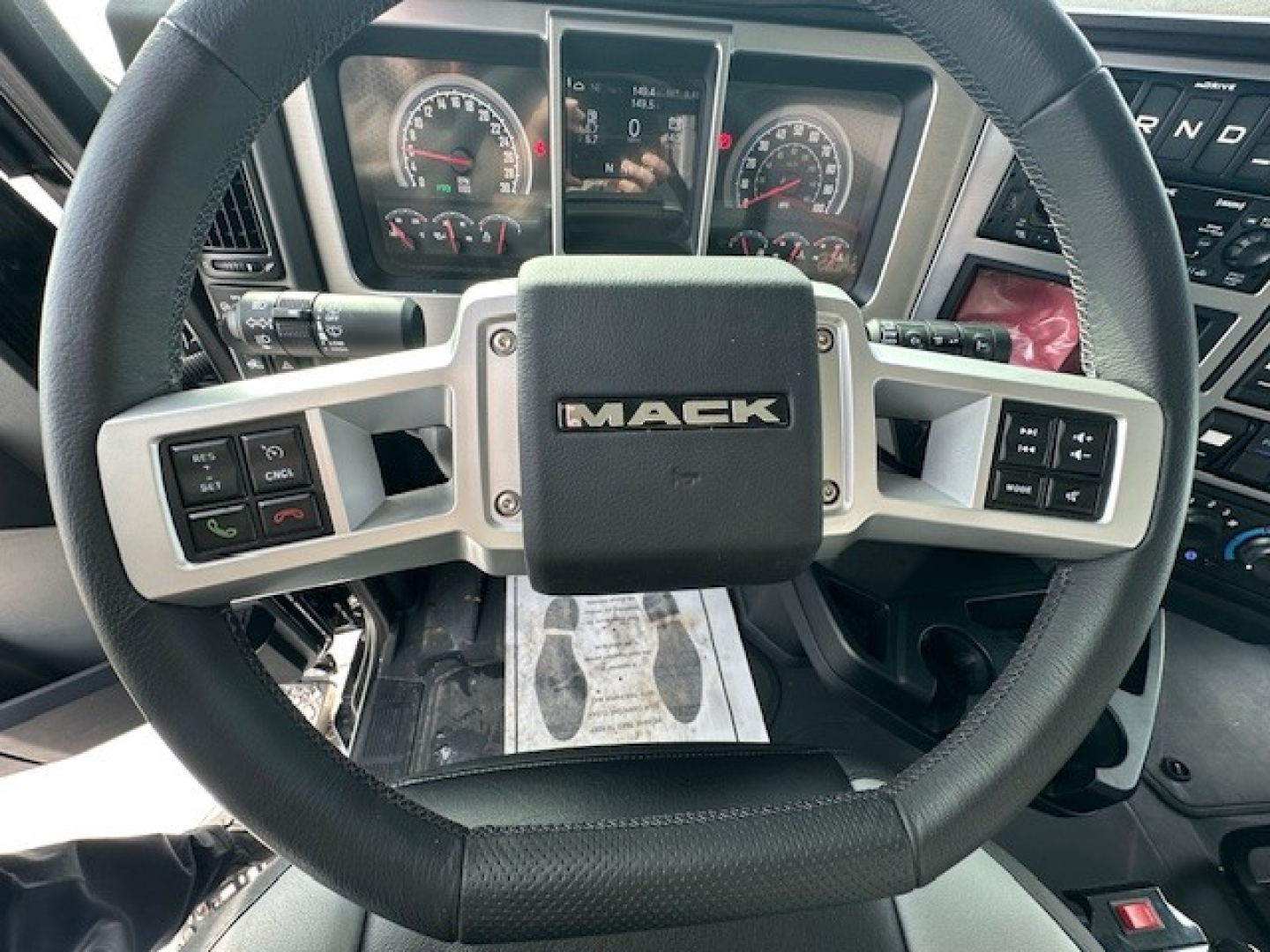 Mack GR104F steering wheel and instrument cluster showing dashboard controls and gauges.