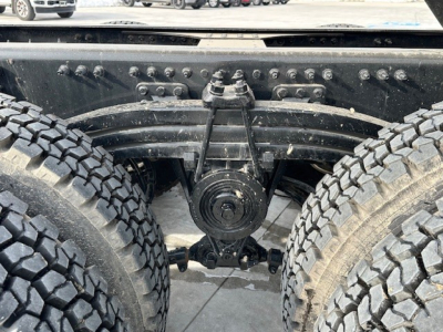 Mack GR104F rear axle and dual tires showing drivetrain components and suspension mounts.