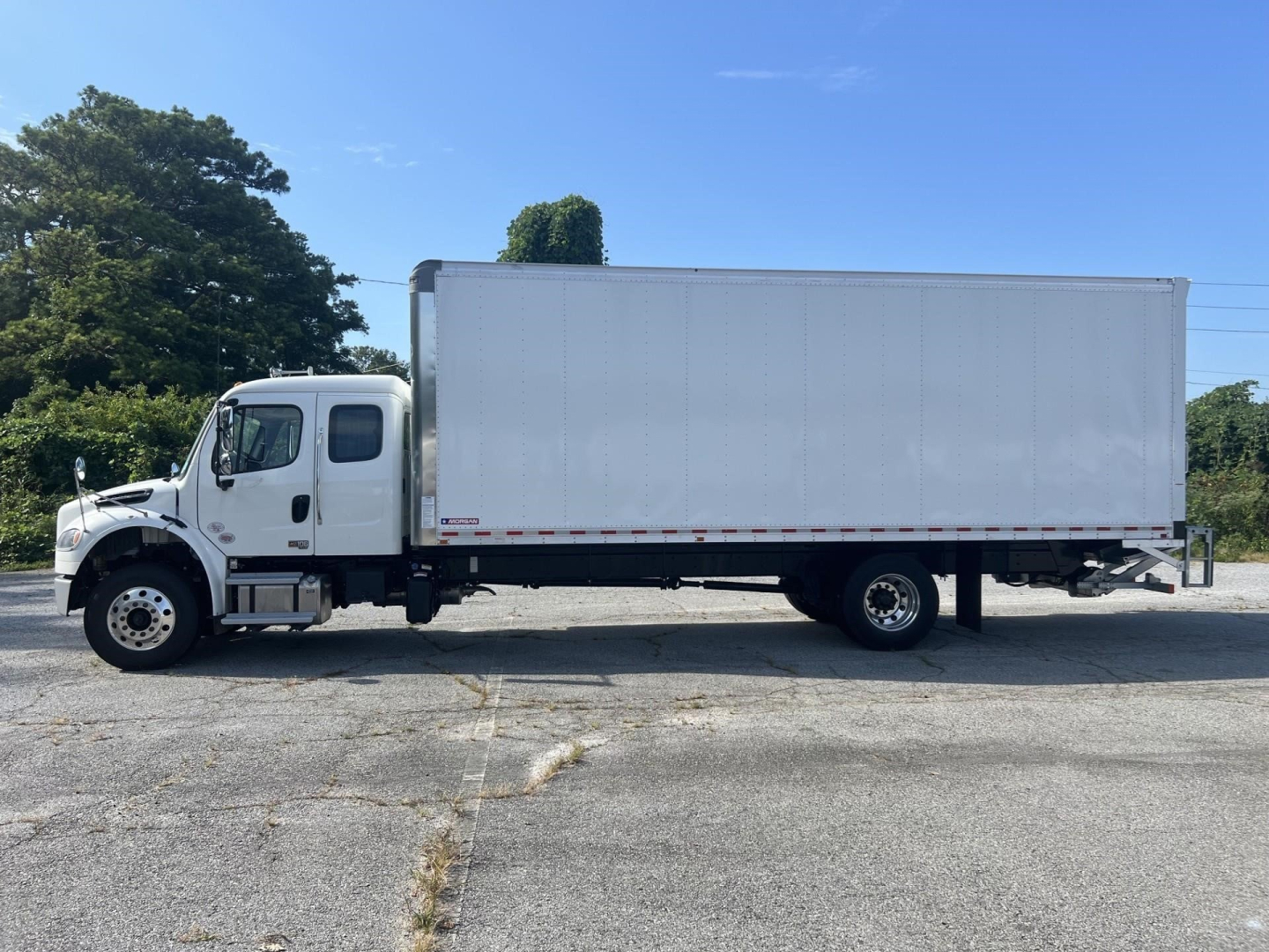 Freightliner M2 106 Plus box truck side view showing cargo box and cab in white
