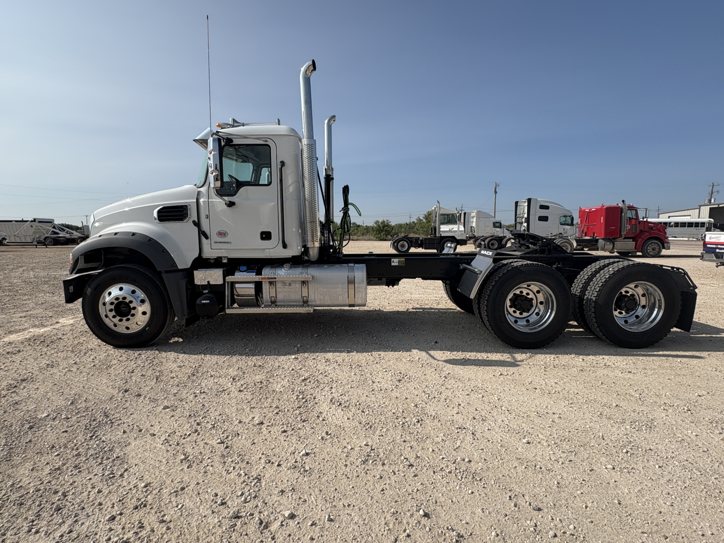 Mack GR64FT truck cab and chassis side profile showing dual rear axles and exhaust stack.