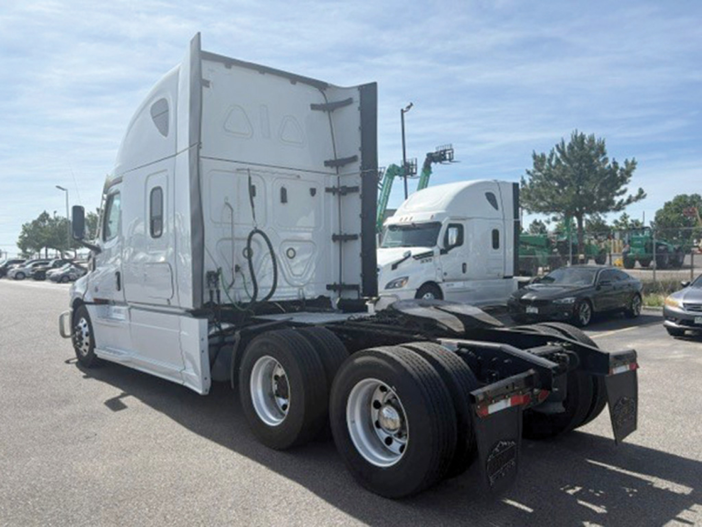 Freightliner Cascadia126 tractor-trailer chassis rear view showing dual rear axles and fifth-wheel mounting platform.