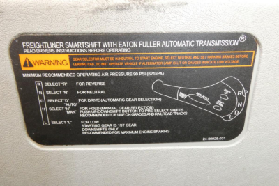 Freightliner SD122 cab label showing Smartshift with Eaton Fuller automatic transmission, operating instructions, warning text, and gear selector diagram.