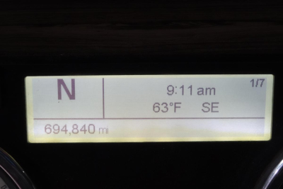 Truck instrument cluster display showing North direction, 9:11 am, 63°F, SE, odometer 694,840 mi.