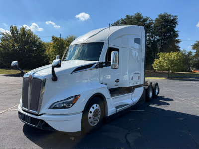 Kenworth T680 truck in white, side view showing cab and front grille, with mirrors and aerodynamic design.
