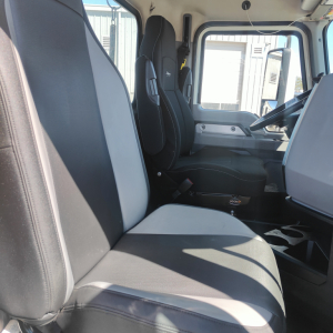 Truck cab interior showing seats and steering wheel in a Mack Anthem daycab.