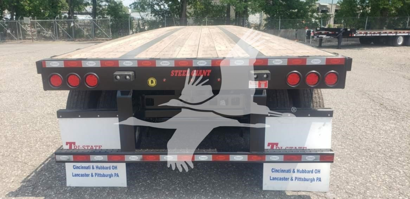 Platform trailer rear view showing flatbed steel deck and taillights on both sides with reflectors and mudflaps, branding reads STEEL TILT? and TW STATE on mudflaps.