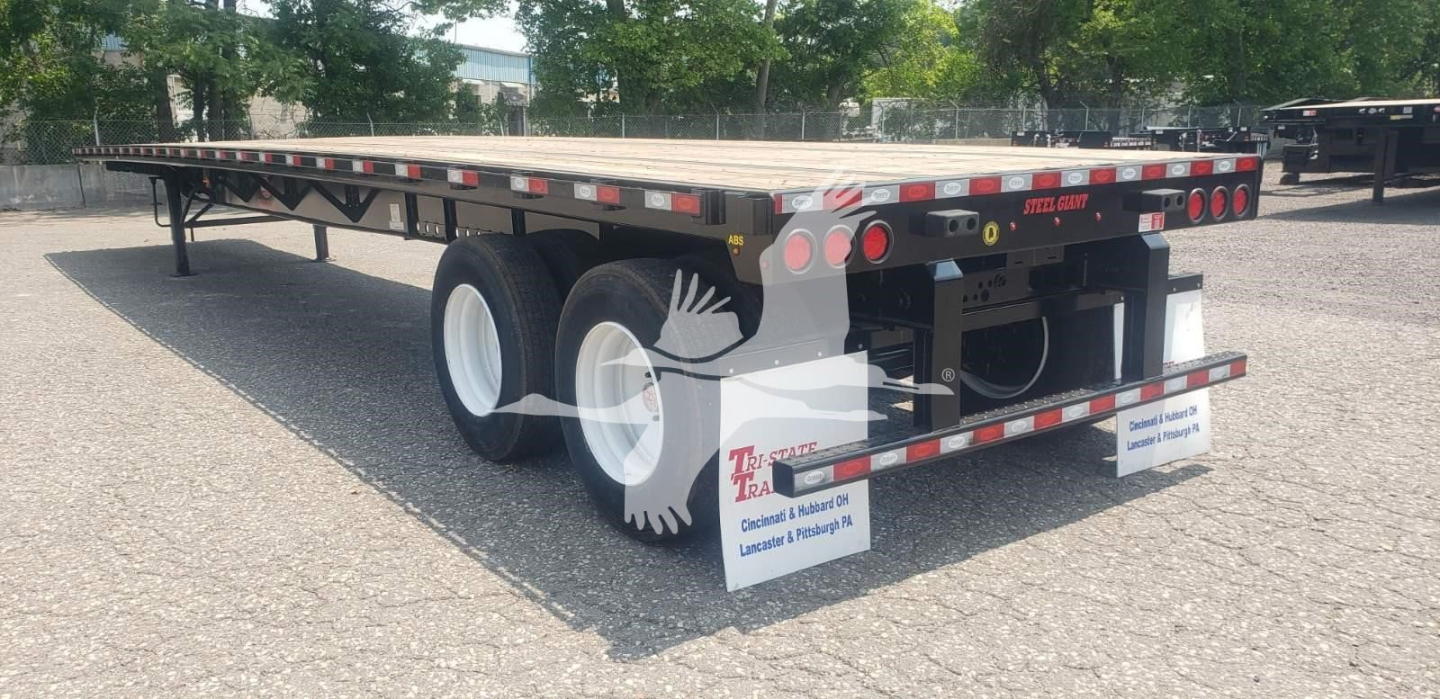 Dorsey steel air sliding tandem trailer showing flatbed and dual axle with white wheels and rear bumper lights.