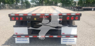 Platform trailer rear view showing flatbed steel deck and taillights on both sides with reflectors and mudflaps, branding reads STEEL TILT? and TW STATE on mudflaps.