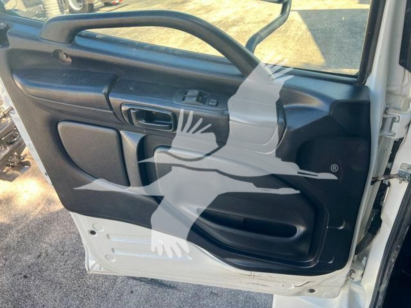 Truck door interior panel with window control and handle; no discernible text visible other than reflected watermark across image.