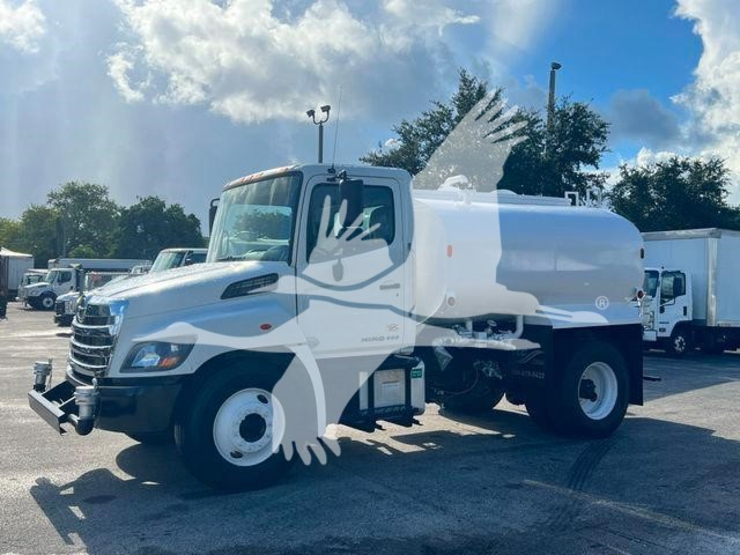 2019 Hino 338 gas or diesel truck in-service showing cab and rear tank with rounded white cylindrical tank and dual rear wheels.
