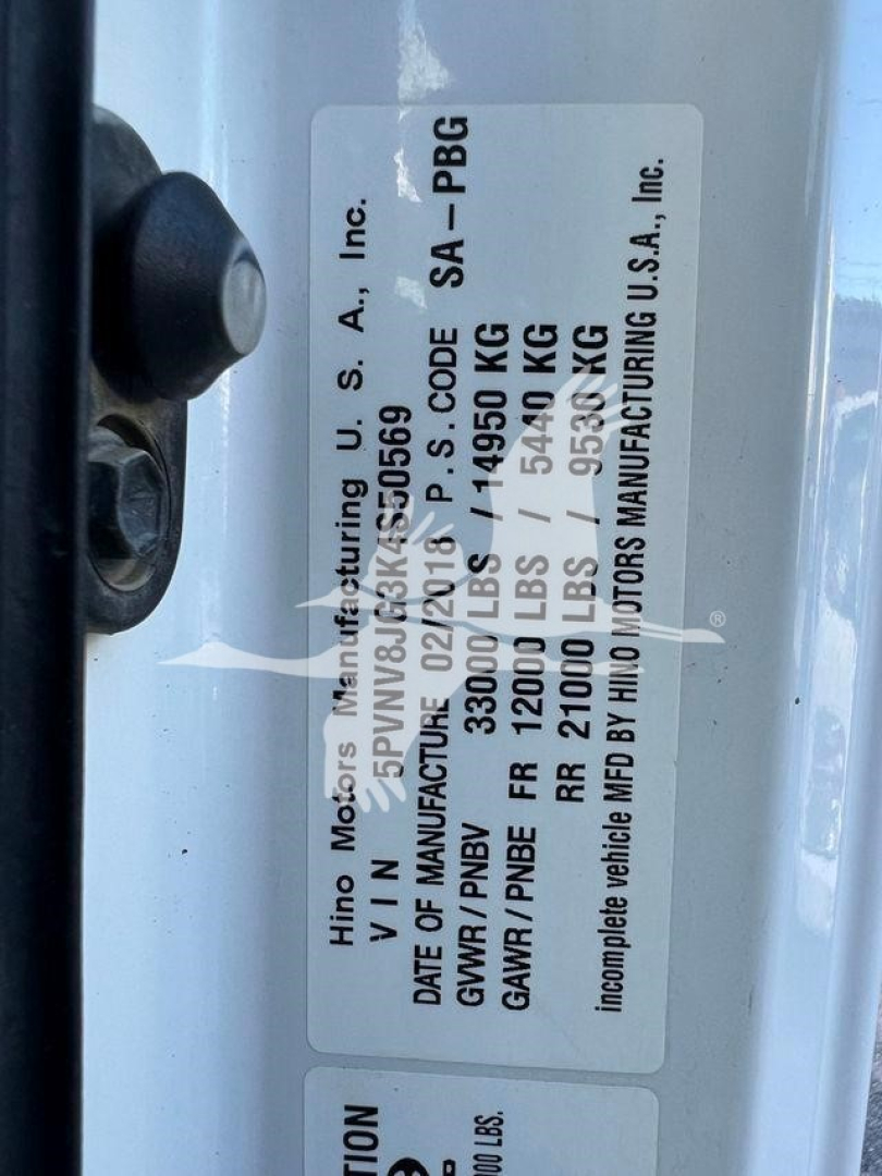 Label on Hino 338 showing VIN, stock, and manufacturing data with vehicle specifications: GVWR, GAWR front/rear, weight, etc.