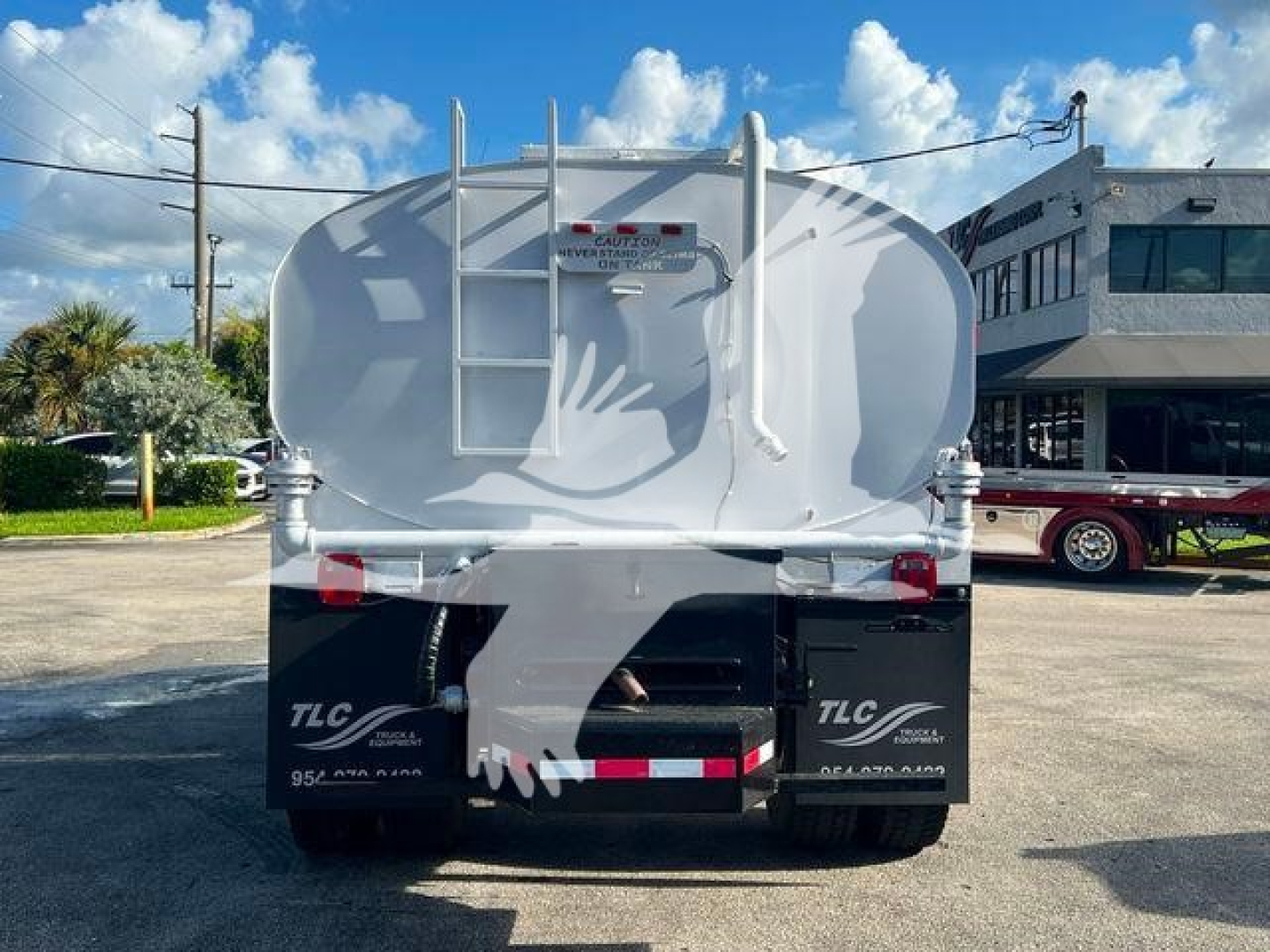 Back view of a white 2019 Hino 338 tanker truck with a rear ladder and twin taillights.