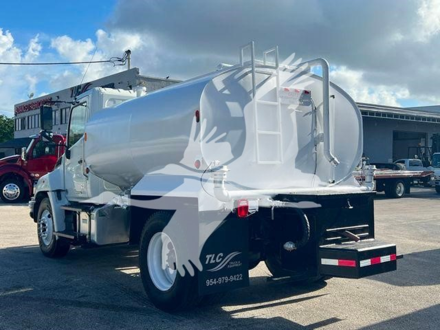 Truck-mounted liquid tanker (Hino 338) with shiny cylindrical stainless tank, rear ladder, and black bumper; side and rear views showing tank and chassis.