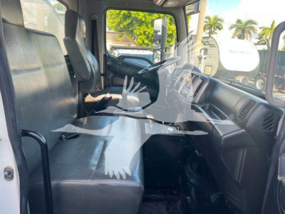 Interior of a 2019 Hino 338 cab showing front bench seat, steering wheel, and dashboard area.
