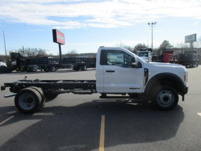 Truck chassis cab showing side view of 2026 Ford F450 cab and chassis, white cab, extended dual rear wheels, VIN 1FDUF4GT6TDA05610 visible in listing context.