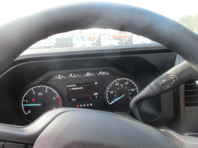 Dashboard view of a Ford F-450 cab and chassis showing instrument cluster and steering wheel with gear indicator PRNDM. Some text on the instrument display reads 'Vehicle On' and there are various gauges.