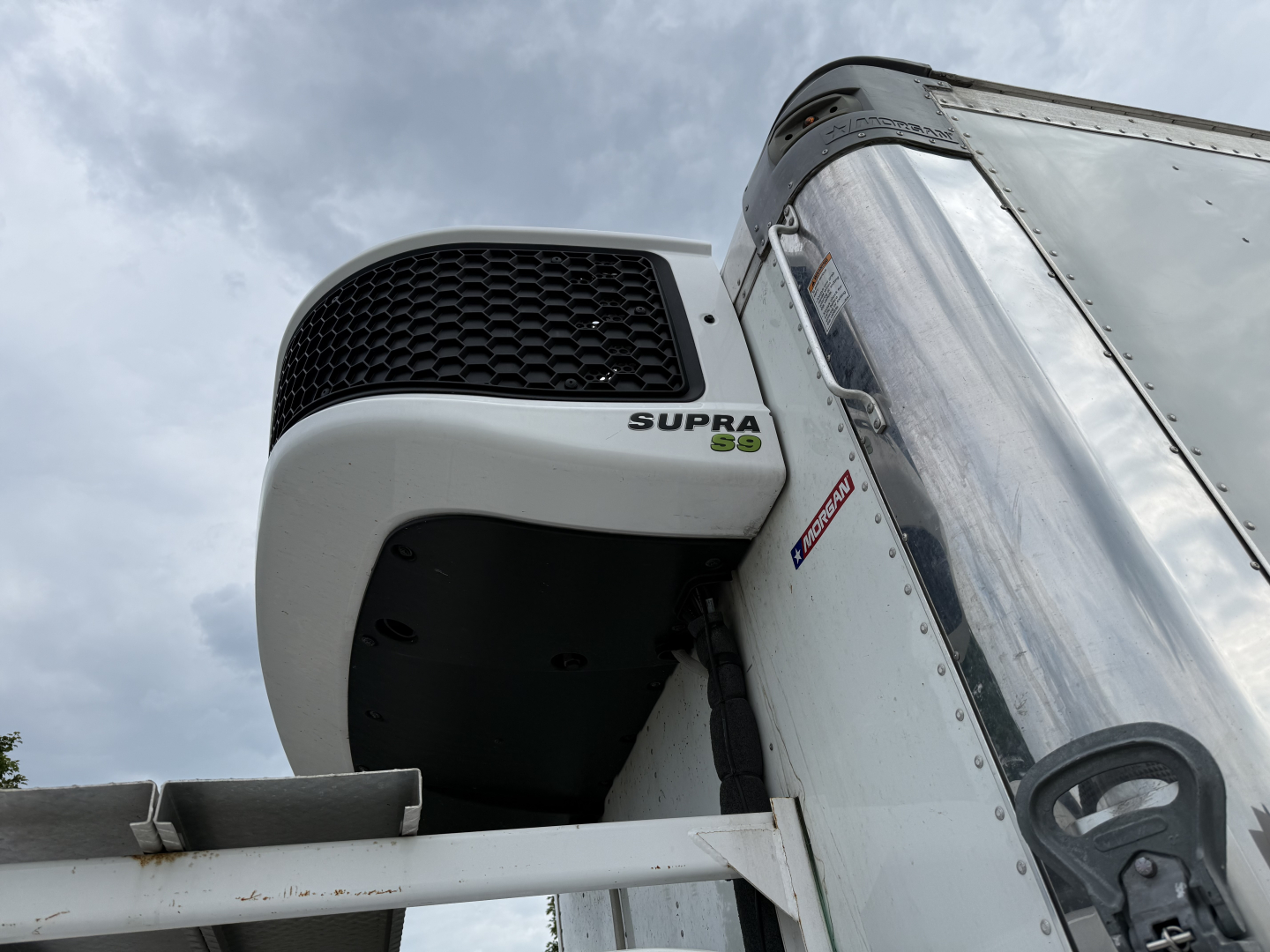 Kenworth T380 refrigerated truck cab area with Supra 95Q refrigeration unit visible on front left side.