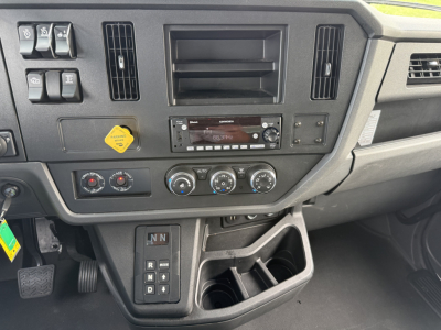 Kenworth T380 dashboard and center console showing climate controls and gear selector with cup holder area.