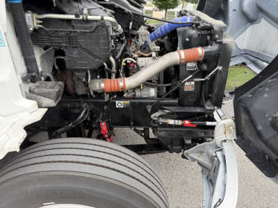 Kenworth T380 engine bay showing coolant hoses, radiator, and suspension components.