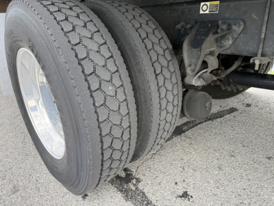 Kenworth T380 rear dual tires and suspension undercarriage view showing trailer hitch and air lines.
