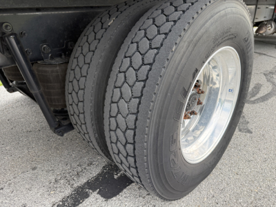 Kenworth T380 truck rear dual wheels with Goodyear tires and chrome wheel rims; visible suspension components and fuel tank area.