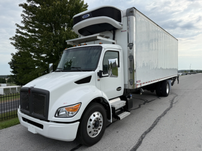 Truck in service showing a Kenworth T380 refrigerated box with a rooftop refrigeration unit and white cab. VIN 2NK4HM7X2PM266510, stock 0627323.