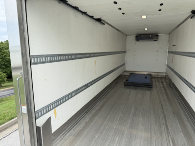 Kenworth T380 refrigerated truck box interior showing empty cargo area with side rails and a floor pallet.