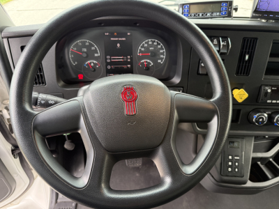 Kenworth T380 steering wheel and dashboard view showing instrument cluster, steering wheel emblem, and control panel.