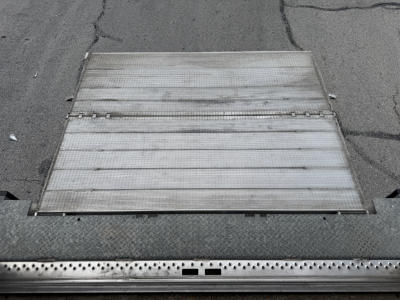 Truck alloy ramp with perforated step edges and track grooves visible; no readable labels or text on the ramp surface.