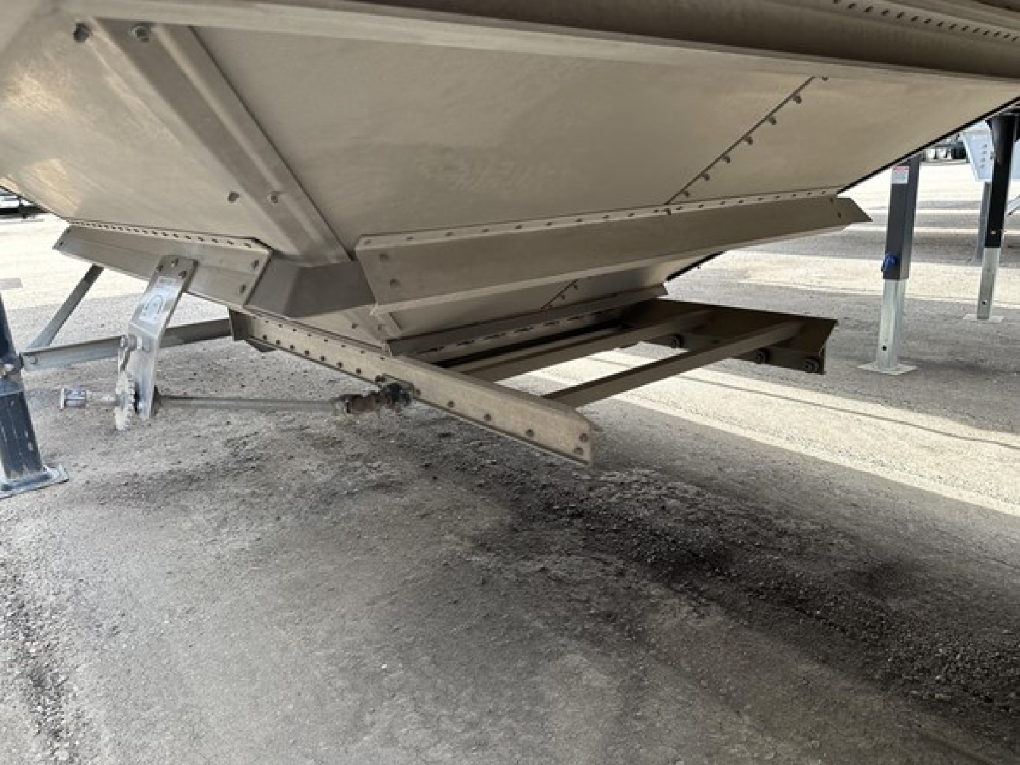 Trailer landing gear and undercarriage of a 2025 Stoughton air ride grain trailer showing structural framework and support beams.
