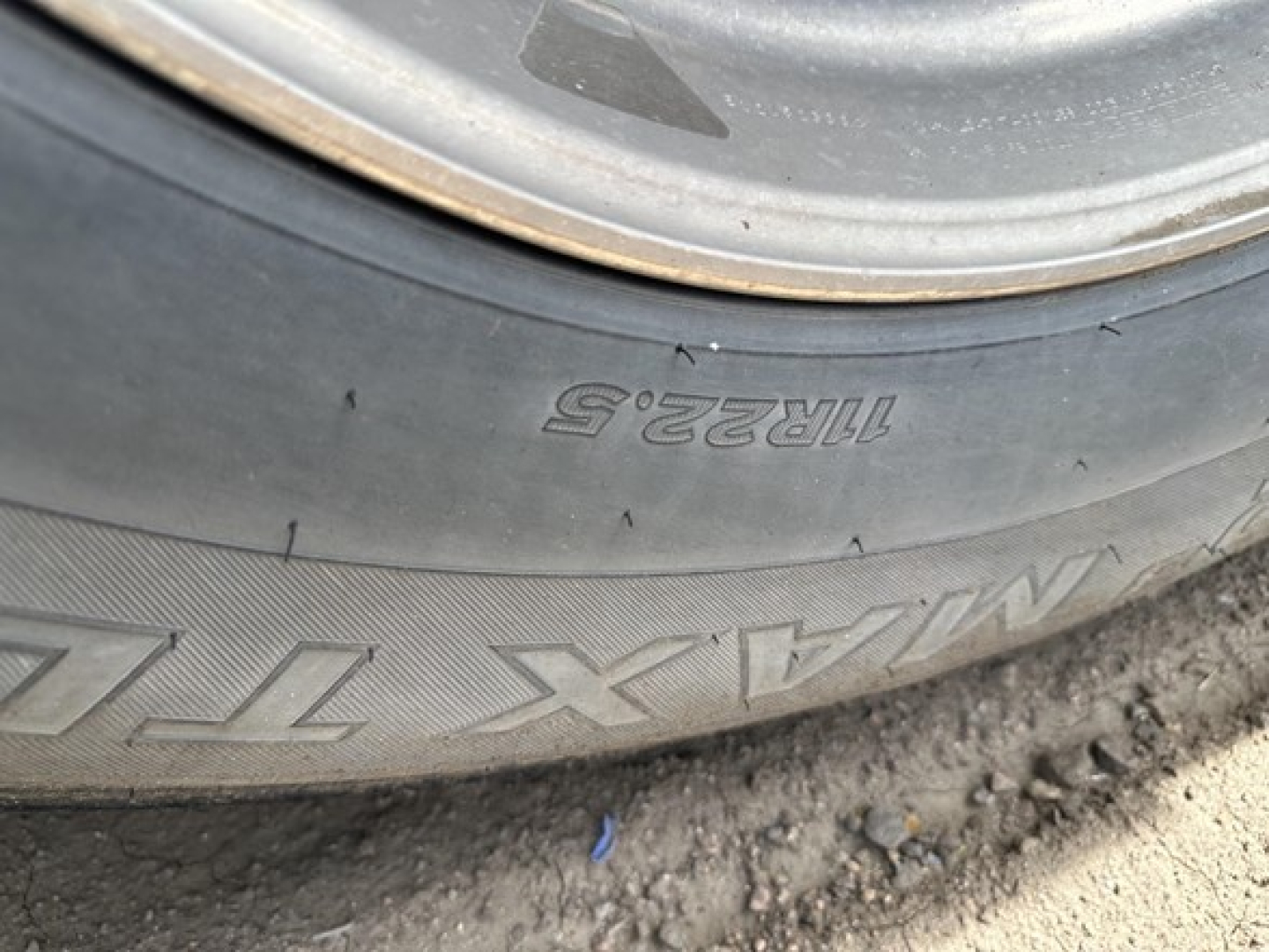 Wheel and tire of a Stoughton trailer showing Goodyear Marathon? tire markings with size 11R22.5 and 11R22.5 inscription and wheel hub.