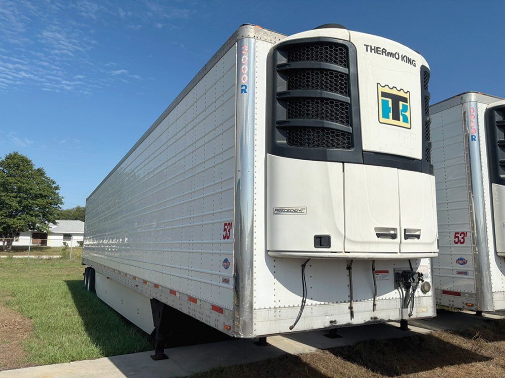 Utility 3000R trailer with Thermo King unit in front, white reefer box, side view showing 53' length and wheels at rear.