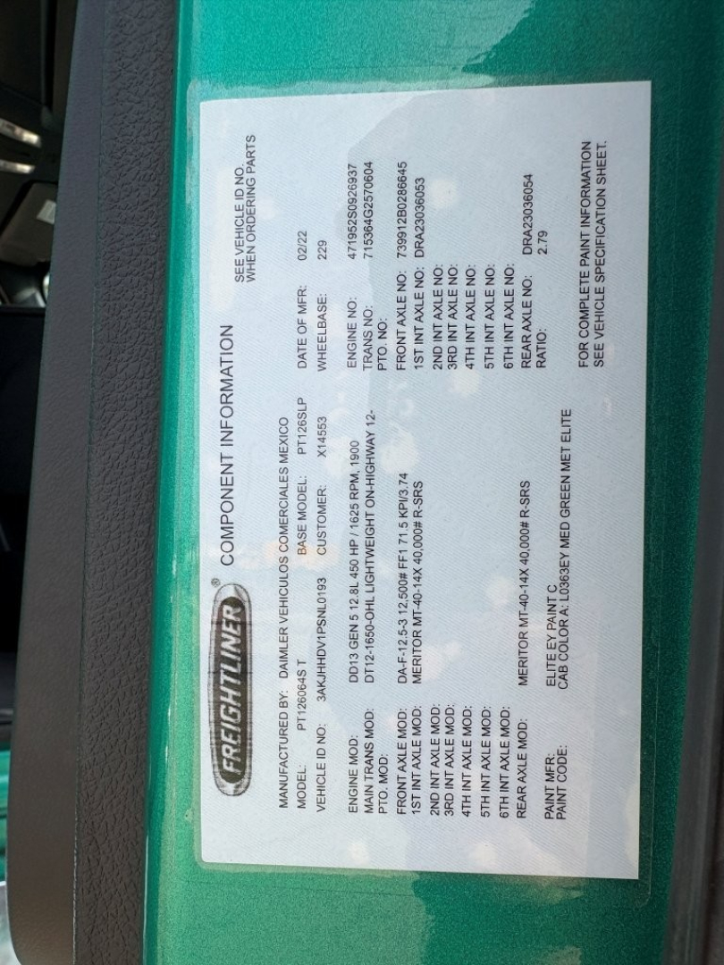 Freightliner information placard on green truck showing component information, VIN, weight ratings, and manufacturer details.