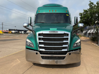 Freightliner Cascadia 126 truck front view showing chrome grille, green cab, and silver bumper.