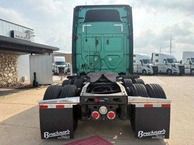 Truck rear view of a 2023 Freightliner Cascadia 126 sleeper tractor showing rear chassis and dual rear axles with mud flaps and taillights.