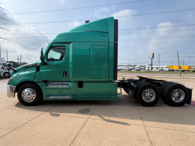 Green Freightliner Cascadia 126 sleeper tractor side view showing cab, fuel tanks, steps, and rear axles with wheels.
