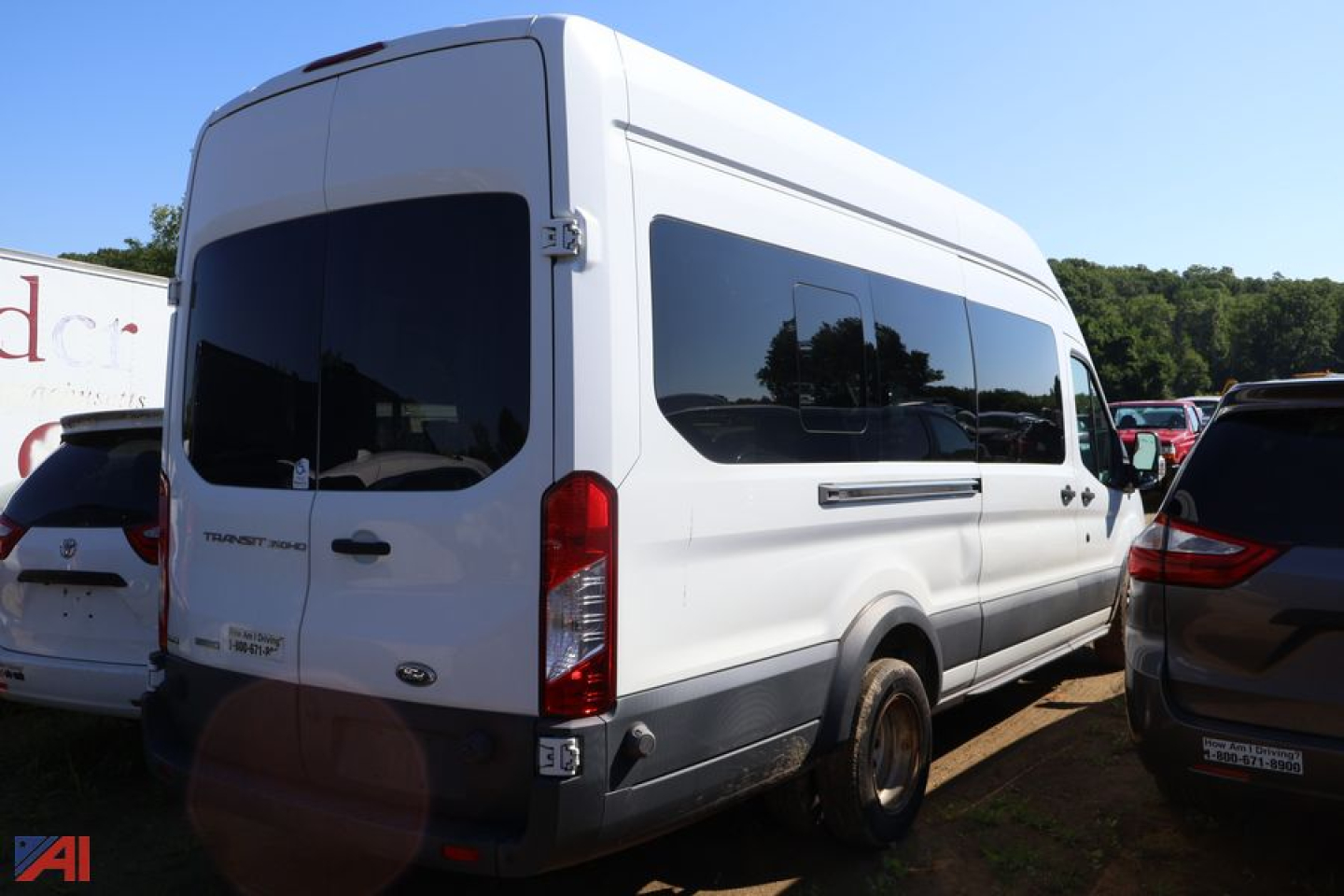 Ford Transit van rear three-quarter view showing side window, rear doors, and taillights.