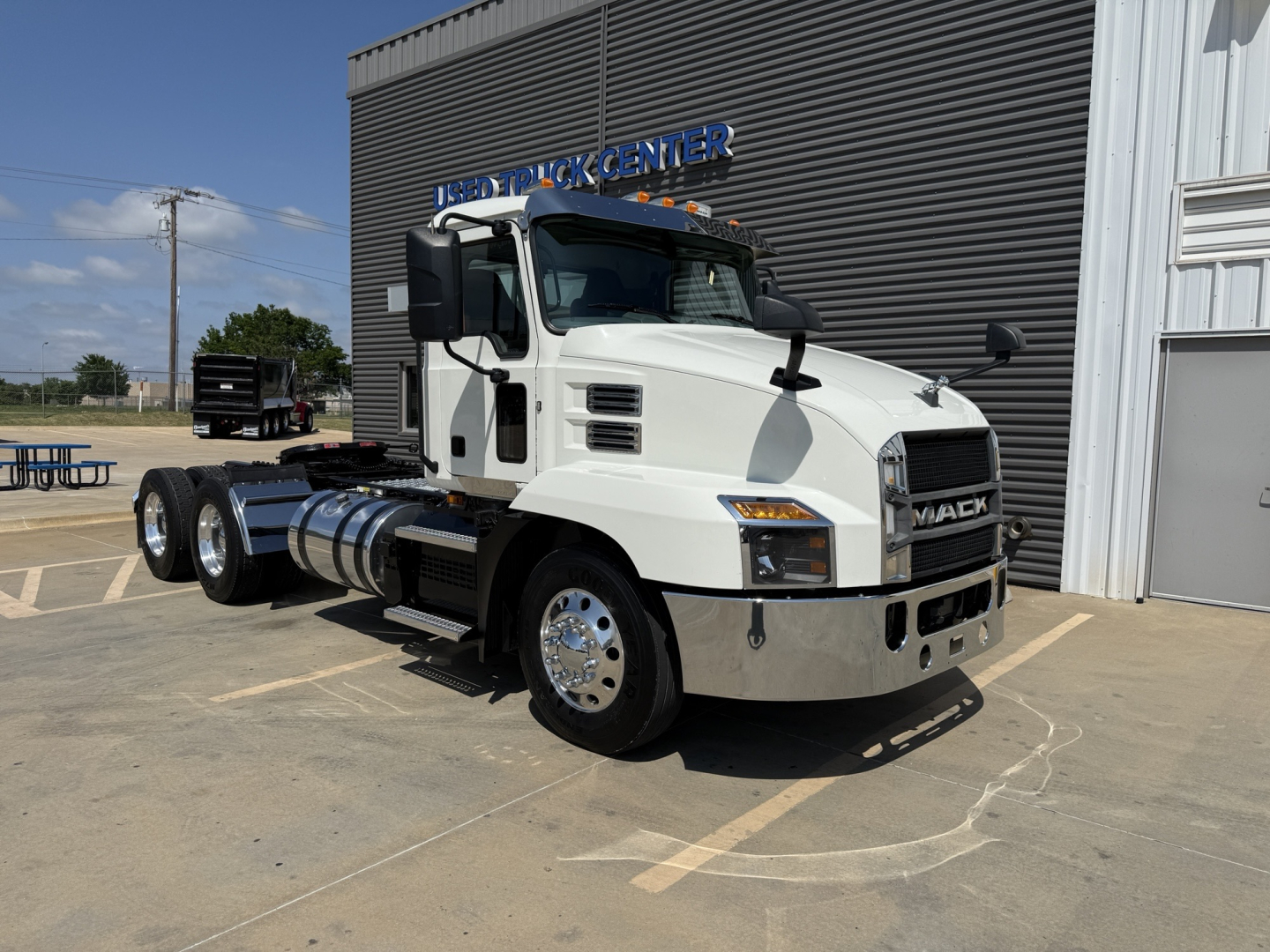 Truck: 2021 Mack AN64T conventional daycab, white, front three-quarter view showing dual rear axles, clean chrome bumper, and Mack grille, VIN 1M1AN2GY3MM022151.