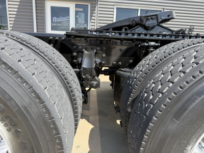 Mack AN64T tractor rear showing dual rear axles and suspension components.