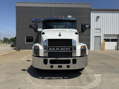 Front view of a white 2021 Mack AN64T truck in a dealership lot with grille, bumper, and headlights visible.