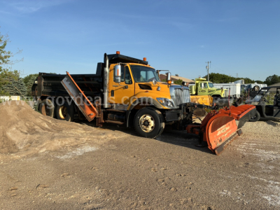 Orange International plow truck with snow plow attachment in a lot, 2009 model year, side view showing front grille and cab.