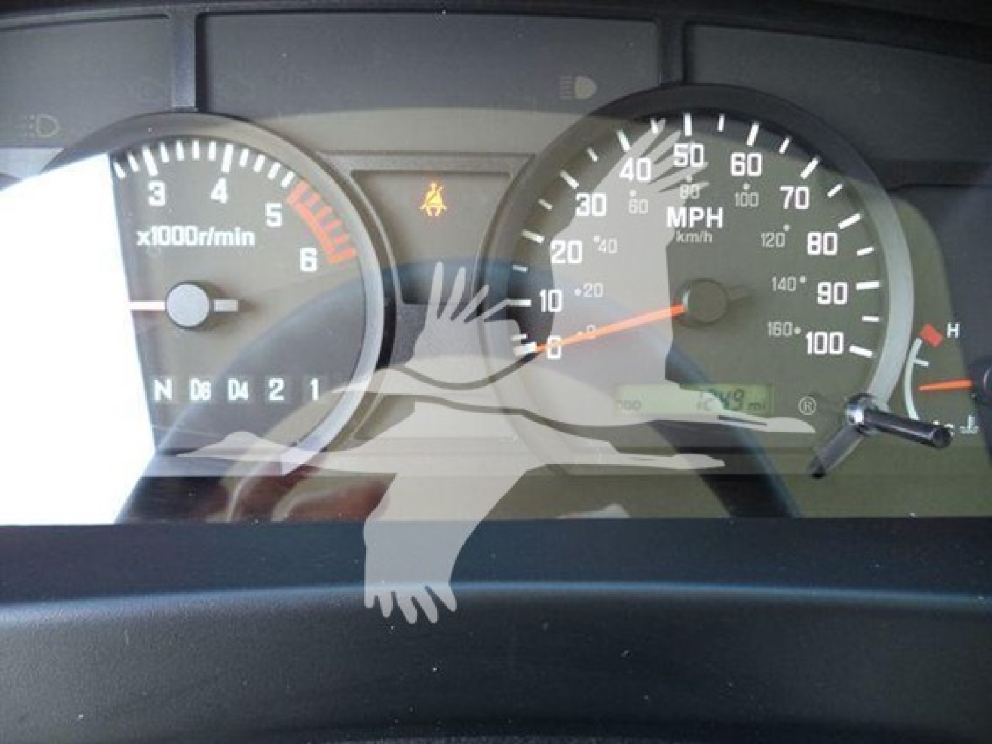 Dashboard view of a 2024 Isuzu NPR-HD showing gauge cluster with tachometer, speedometer, and warning indicators.