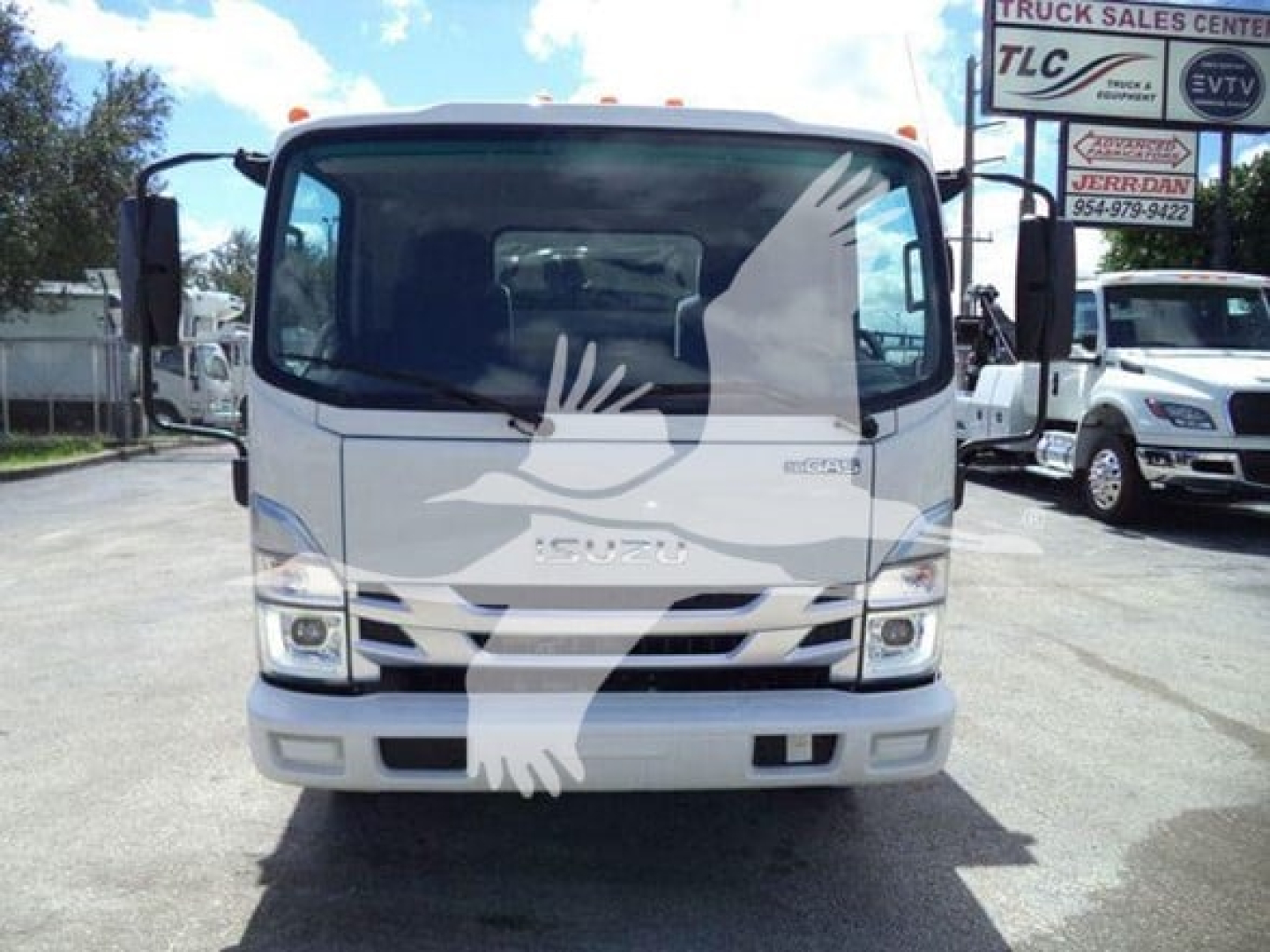 Isuzu NPR-HD truck front view in a dealership lot showing cab and grille, stock number T10448, windshield, headlights, and bumper.
