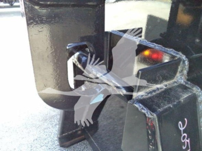 Isuzu NPR-HD truck hitch/fifth wheel hitch area with metal hitch mechanism and cut metal brackets.